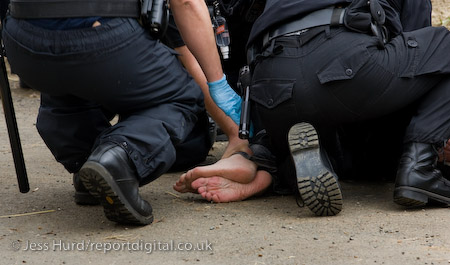 Police body wrap a protester who refuses to be searched leaving the camp. Climate Camp calls for the government to take action on climate change and stop the bulding of Kingsnorth coal fired electricity station. Rochester, Kent.
© Jess Hurd/reportdigital.co.uk
Tel: 01789-262151/07831-121483  
info@reportdigital.co.uk  
NUJ recommended terms & conditions apply. Moral rights asserted under Copyright Designs & Patents Act 1988. Credit is required. No part of this photo to be stored, reproduced, manipulated or transmitted by any means without permission.