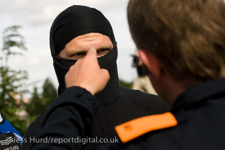 Policeman tells a protester to take his balaclava off. Day of Direct Action. Climate Camp calls for the government to take action on climate change and stop the bulding of Kingsnorth coal fired electricity station. Rochester, Kent.
© Jess Hurd/reportdigital.co.uk
Tel: 01789-262151/07831-121483  
info@reportdigital.co.uk  
NUJ recommended terms & conditions apply. Moral rights asserted under Copyright Designs & Patents Act 1988. Credit is required. No part of this photo to be stored, reproduced, manipulated or transmitted by any means without permission.