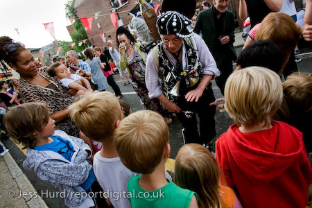 Entertainer Jake Rodriguiez teaches local kids how to play the spoons. Gawber Street Festival, possibly londons smallest street festival. Tower Hamlets, East London.
© Jess Hurd/reportdigital.co.uk
Tel: 01789-262151/07831-121483  
info@reportdigital.co.uk  
NUJ recommended terms & conditions apply. Moral rights asserted under Copyright Designs & Patents Act 1988. Credit is required. No part of this photo to be stored, reproduced, manipulated or transmitted by any means without permission.