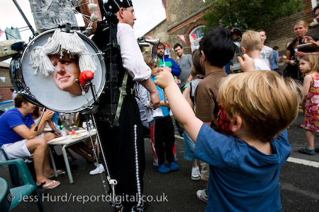 Entertainer Jake Rodriguiez uses Boris Johnson as a drum. Gawber Street Festival, possibly londons smallest street festival. Tower Hamlets, East London.
© Jess Hurd/reportdigital.co.uk
Tel: 01789-262151/07831-121483  
info@reportdigital.co.uk  
NUJ recommended terms & conditions apply. Moral rights asserted under Copyright Designs & Patents Act 1988. Credit is required. No part of this photo to be stored, reproduced, manipulated or transmitted by any means without permission.